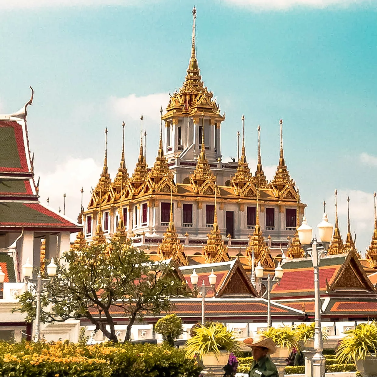 This image features a stunning example of Thai architecture, specifically the Loha Prasat, located at the Wat Ratchanatdaram temple in Bangkok, Thailand.